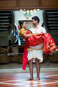 a man and woman dressed in traditional thai garb dance together on the dance floor