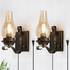 two wall lights with glass shades on them