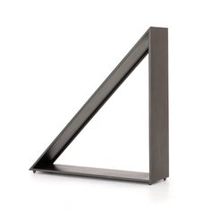 a metal shelf with a triangle shaped object on it's side, against a white background