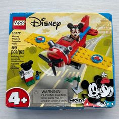 the box is open to reveal an image of mickey mouse in a plane with other toys