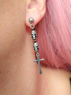 Stunning gothic/ punk style skull and cross stud earrings in silver  ☠️  Unisex. Made of 100% stainless Steel so are hypoallergenic and won't tarnish or discolour. Available as a single earring or as a pair. Total length of earrings: 55mm Comes gift wrapped 🖤  Please don't hesitate to contact me with any queries or suggestions 😊 Gothic Piercings For Halloween Gift, Silver Metal Emo Earrings, Silver Metal Emo Style Earrings, Silver Punk Cartilage Earrings, Punk Cross Jewelry For Halloween, Skull-shaped Metal Earrings, Edgy Metal Cross Jewelry, Punk Style Cross Jewelry For Halloween, Handmade Punk Style Cross Jewelry