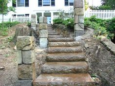 stone steps leading up to a white house