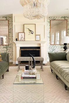 a living room with two couches and a coffee table in front of a fireplace