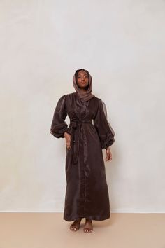 The Organza Abaya is statement outfit for any event. It's super lightweight yet so simple with the prettiest sheen. Complete the look with our matching long sleeve satin slip dress and a pair of strappy heels for a luxe finish or make it into a more casual look. Model is wearing a size Small Model Measurements: Height 5'8. Waist 25", Bust 32", Hips 37" *Please note that the color displayed in the picture might be slightly different due to the color resolution and lighting. Fabric Description & C Formal Long Sleeve Silk Abaya, Elegant Silk Abaya With Long Sleeves, Elegant Long Sleeve Silk Abaya, Elegant Silk Abaya For Eid, Elegant Evening Abaya For Fall, Silk Long Sleeve Abaya For Party, Silk Long Sleeve Party Abaya, Elegant Long Sleeve Satin Abaya, Silk Abaya For Eid Party