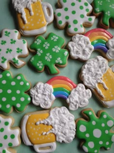 decorated cookies with shamrocks, rainbow and pot of gold on green tableclothed surface