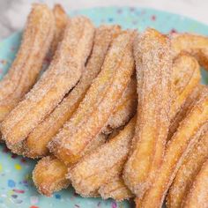 some sugar coated churros are on a blue plate