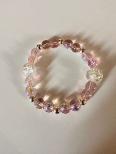 "This is a handmade bracelet.  Very pretty pink color with silver accent beads on a stretchy elastic. Would fit a 7\" wrist easily.  The accent pieces are crystal looking with sparkles inside.   The silver beads really make the pink beads sparkle! Picture taken in different lighting to show how it looks under different settings. We offer free shipping on all of our items! If you are interested in a certain color combination, please send me a private message to see if we have your desired colors Adjustable Pink Beaded Bracelet With Silver Beads, Pink Beaded Stretch Bracelet For Party, Pink Faceted Beads Bracelets For Party, Pink Adjustable Crystal Bracelet With Round Beads, Pink Crystal Bracelet With 8mm Beads For Party, Adjustable Pink Crystal Bracelet With Faceted Beads, Pink Crystal Bracelet With Round Beads For Party, Adjustable Pink Crystal Bracelet With Round Beads, Elegant Pink Hypoallergenic Beaded Bracelets