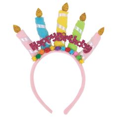 a pink headband with candles and pom poms