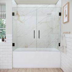 a bathroom with white walls and wood flooring has a glass shower door that is open to the outside