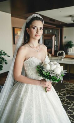 a woman in a wedding dress holding a bouquet and posing for a photo on her instagram page