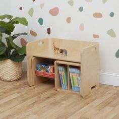 a child's wooden book shelf with books on it