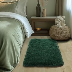 a bedroom with a green rug on the floor next to a bed and nightstands