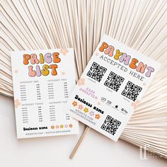 two tickets sitting next to each other on top of a white table with popsicle sticks