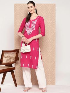 A charming hot pink and white cotton kurta, meticulously adorned with floral embroidered Chikankari detailing. The straight shape enhances its elegant silhouette, making it a perfect blend of traditional craftsmanship and contemporary style. Single Piece Fabric: Cotton Color: Pink & White Neck: Round Neck Sleeve: 3/4th Sleeves Style - Straight Shape with Regular Style Work Done: Floral Embroidery with Chikankari Detailing Length - Calf Length Washing Instructions: Hand Wash Size & Fit - Model's Kurta Style, Kurta Design, Cotton Kurta, Pink Solid, Kurta Designs, Womens Size Chart, Top Fabric, Pink Fabric, Sleeve Detail