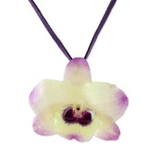 A real Dendrobium Orchid preserved in resin is showcased in this pendant necklace presented by Danai of Thailand. The orchid has pale yellow petals tipped in purple and hangs from a deep purple leather cord. Two sliding tiger's eye beads dyed purple secure the ends of the cord and allow the necklace length to be adjusted. Dendrobium Orchid, Orchid Necklace, Yellow Petals, Dendrobium Orchids, Purple Orchids, Beautiful Orchids, Tiger Eye Beads, Flower Pendant Necklace, Flower Petal