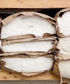 several bags of white bread sitting on top of a wooden pallet