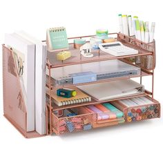 an organized desk with books, notebooks and pens