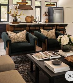 a living room filled with lots of furniture next to a counter top covered in flowers