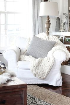 a living room with a white couch and lamp