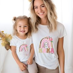 Introducing our adorable Mommy and Me Abstract Rainbow T-shirts set! These matching tees are perfect for creating precious twinning moments with your little one. The vibrant abstract rainbow design adds a fun and stylish touch to your outfits, making it perfect for family outings, pictures, or just lounging at home. Made from soft and comfortable materials, these shirts are great for all-day wear and are sure to become a favorite in your wardrobe. Celebrate your special bond with your mini me in Personalized Pink T-shirt For Mother's Day, Matching Mother’s Day Birthday T-shirt, Matching T-shirt For Birthday And Mother's Day, Personalized Matching T-shirts As Gifts, Cute White T-shirt With Custom Name, Personalized Graphic Tee For Mother's Day, Customizable T-shirt For Mother's Day, Personalized Family Matching Pink T-shirt, Family Matching Custom Name T-shirt As A Gift