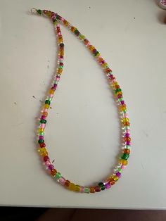 Enhance your style with this stunning 16-inch beaded necklace, meticulously handcrafted to bring a touch of elegance to any outfit. The necklace features high-quality beads, arranged in a delicate pattern, and is finished with a durable gold-plated clasp that ensures a secure and comfortable fit. Perfect for special occasions or everyday wear, this beaded necklace adds a sophisticated flair to your jewelry collection. Whether you're dressing up for a formal event or looking to add a touch of glamour to your casual ensemble, this versatile necklace is the ideal accessory. Key Features: Length: 16 inches Material: High-quality beads Clasp: Gold-plated, secure fit Handmade with care Ideal for gifting on birthdays, anniversaries, or holidays Please note that this item is one-of-a-kind and hand Adjustable Beaded Necklace With Polished Oval Beads, Multicolor Single Strand Crystal Necklace With Round Beads, Single Strand Beaded Necklace With Oval Beads For Gift, Single Strand Beaded Necklace With Oval Beads As Gift, Adjustable Single Strand Beaded Necklace With Oval Beads, Beaded Necklaces, Fruit Salad, Formal Event, Favorite Jewelry