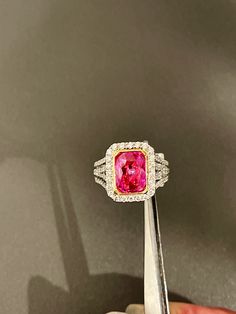 Oval cut pink sapphire weighing 3.06cts mined in Madagascar in a bright electric pink color and certified by Stone Group Laboratories.  The stone is bezel set in 18kt yellow gold and the ring is 18kt white gold bead set with round beautiful cut diamonds weighing approximately 1.30cts with clarity and color approximately VS1, F-G. This ring can be sized to your speciations. Gia Certified Luxury Pink Ruby Ring, Luxury Gia Certified Pink Sapphire Ring, Gia Certified Fine Jewelry Pink Sapphire Diamond Ring, Fine Jewelry Gia Certified Pink Sapphire Diamond Ring, Gia Certified Pink Sapphire Diamond Ring In Fine Jewelry, Gia Certified Pink Diamond Ruby Ring, Gia Certified Pink Sapphire Diamond Ring, Luxury Pink Gia Certified Diamond Ring, Pink Diamond Sapphire Ring, Gia Certified