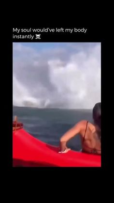 a woman in a red kayak on the ocean with her back to the camera