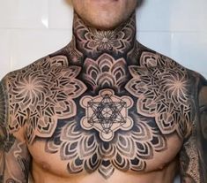 a man with tattoos on his chest and chest