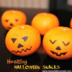 five oranges with faces drawn on them and the words healthy halloween snacks written below