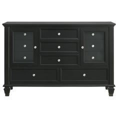 a black dresser with drawers and knobs on the bottom, in front of a white background