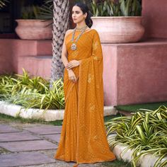 Mustard colored saree is made from chiffon fabric which is highlighted with beautiful foil printed & swarovski work as shown. Comes along with unstitched banglori blouse piece which you can customise as per your design/style. Occasion - You can wear this saree for festive, functions and fashionista. Note:- the actual product may differ slightly in color and design from the one illustrated in the images when compared with computer or mobile screen. Measurements: Saree : Chiffon : 5.5 Mtrs Blouse : Chiffon : 0.8 Mtr Material: Chiffon Stitch Type: Unstitched Country of Origin: India Care Guide: Dry Clean Saree Chiffon, Blouse Chiffon, Party Wear Indian Dresses, Mobile Screen, Silk Lehenga, Chiffon Saree, Foil Print, Chiffon Fabric, Blouse Piece