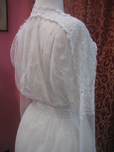 "1914, 36\" bust , elaborate cotton lace on net, wedding dress. dress has lace edged net apron, beneath belt, around hips. Bodice is entirely worked in lace, and has a narrow lace ruffle edged alone V shaped neckline. Sleeves are long with lace cuffs, with a net middle, and a lace band around the upper arm. The gown is fastened in front with hooks and eyes from bodice to waist, and snaps from waist to thigh. Measurements: bust 36\" waist 26\" shoulder to shoulder 17\" sleeves 21\" arm holes 9\" Vintage Lace With Lace Trim For Ceremony, Victorian Lace Trim Dress For Vintage Events, Fitted Victorian Lace With Lace Trim, Victorian Lace Dress With Lace Collar, Historical Victorian Dress With Lace Trim For Wedding, Historical Victorian Wedding Dress With Lace Trim, Victorian Wedding Dress With Lace Sleeves, Regency Style Victorian Dress With Lace Collar For Wedding, Vintage White Lace Patchwork For Wedding