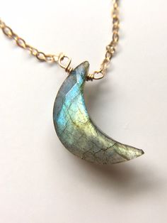 18mm This Gold or Silver Labradorite Gemstone Crescent Moon pendant necklace is the perfect healing piece to add to your jewelry collection. Exuding It's magical shades of yellow blue and green, labradorite helps awaken your soul and embraces self- discovery. Embrace the delightful beauty and tranquil benefits of this gentle and graceful creation. Made to order Labradorite Moon Necklace *Beautifully faceted and colorful labradorites variety of colors including blue and green *Edgy and Boho Chic Moon Necklace Gold, Calm Energy, Green Labradorite, Crescent Moon Necklace Gold, Raw Stone Necklace, Gold Moon Necklace, Raw Crystal Jewelry, Crescent Moon Pendant, Moon Pendant Necklace