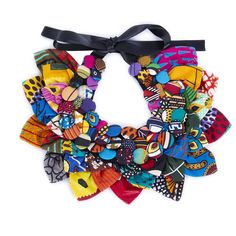 a multicolored necklace with black ribbon and bow on white backgroung