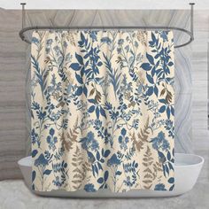 a shower curtain with blue and white flowers on it in front of a marble wall