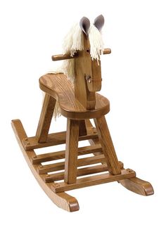 a wooden rocking horse with white fur on it's head