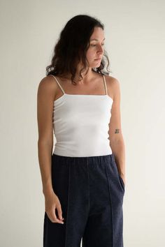 Ribbed tube top with spaghetti straps.    96% cotton 4% poly.    one size.  made in japan. Seamless Cotton Spaghetti Strap Tops, Everyday Cotton Camisole With Spaghetti Straps, Everyday Cotton Camisole, Casual Fitted Camisole With Spaghetti Straps, Cotton Camisole Top With Adjustable Straps, Casual Stretch Tube Top With Spaghetti Straps, Cotton Cami Tops For Everyday Wear, Fitted Cotton Camisole Tank Top, Seamless Fitted Cotton Tank Top