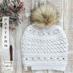 a crochet hat with a pom - pom on top and the pattern next to it