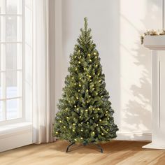 a small christmas tree with yellow lights in a room