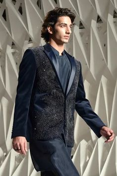 Dark teal palladian embellished tuxedo, highlighted with metallic crystals and satin detailed shawl collar.
Component: 1
Pattern: Embellished 
Type Of Work: Beads,Crystals
Neckline: Shawl Lapel Collar
Sleeve Type: Full Sleeves
Fabric: Velvet
Color: Blue
Other Details: 
Single button closure
Note: Inner kurta and trouser worn by the model is not for sale
Occasion: Party,Sangeet - Aza Fashions Luxury Embellished Party Sets, Elegant Party Sherwani With Mirror Work, Elegant Embellished Sherwani For Festive Occasions, Elegant Embellished Bandhgala For Festive Occasion, Formal Hand Embellished Sets, Elegant Embellished Festive Bandhgala, Formal Hand Embellished Party Sets, Hand Embellished Sets For Formal Party, Elegant Festive Embellished Sherwani