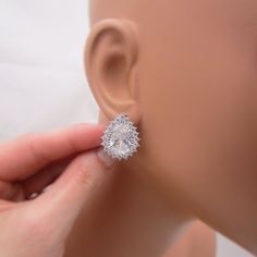 These bridal earrings are perfect for brides that don't have pierced ears. They are made with lovely clip on bases that feature a soft cushion insert for the clip. The focal rhinestone teardrop is surrounded with tiny sparkling crystals for a statement piece. Total earring length is approximately 7/8 inch long. Comes in a gift box. See our other clip on styles here:www.etsy.com/shop/AnaInspirations?ref=seller-platform-mcnav&search_query=clip+onSHIPPING: This item ships by USPS First Class Mail. Silver Teardrop Clip-on Crystal Earrings, Silver Teardrop Crystal Clip-on Earrings, Formal Teardrop Crystal Clip-on Earrings, Teardrop Crystal Clip-on Earrings For Formal Occasions, Hypoallergenic Pear-shaped Wedding Earrings, Silver Teardrop Clip-on Earrings For Wedding, Hypoallergenic Pear-shaped Teardrop Earrings For Wedding, Silver Drop Clip-on Earrings For Wedding, Hypoallergenic Teardrop Earrings For Wedding