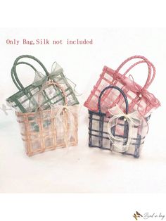 two small bags with bows on them sitting next to each other in front of a white background