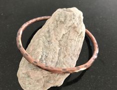 Copper Bangle Bracelet - This is a listing for one handmade pure copper bangle bracelet that fits very comfortably and can be worn daily. It is forged out of new 6 gauge pure copper wire. I annealed a single piece of wire, hammered it uniformly for a perfect texture, fused the ends, and formed it into the desired size bracelet. After shaping, it was tumbled in a jewelers mix to polish for a smooth comfortable wear. Finally, it was oxidized to achieve a really nice patina finish. This is a very n Artisan Electroformed Bangle Bracelets, Hammered Copper Bangle Bracelet, Hand Forged Copper Bangle Bracelet, Hammered Copper Bangle Bracelets, Handmade Copper Bangle Bracelets, Copper Bangle Gift, Handmade Copper Bangle, Patina Copper, 7th Anniversary Gifts