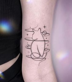 a woman's arm with a cat tattoo on the left side of her body