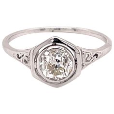 an antique style diamond ring with filigrees