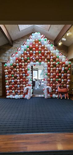 an entrance decorated with balloons and christmas decorations