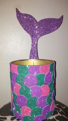 a purple and green cup with a mermaid tail on it