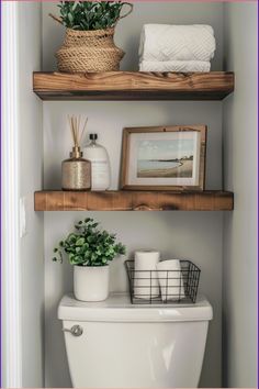 a bathroom with two shelves above the toilet