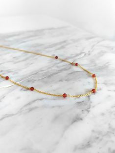 Ambrosia. Inspired by ambrosia, the food of greek gods. This necklace is composed of 14K gold vermeil delicate chain and natural carnelian gemstones. So pretty for everyday! It also makes a very cute gift! Gemstone bar is 1 inch/2,5 cm long You can choose between 4 chain lengths: 14 / 15 / 16 / 18 inches Not sure which length to buy? We can add a 1 inch extender chain. Just write a note at checkout! Other carnelian bracelet: https://www.etsy.com/listing/952670287 Similar necklace: https://www.et Gold Plated Jewelry With Natural Stones For Gift, Minimalist Amber Pendant Necklace, Handmade Spiritual Chain Necklace For Gift, Delicate Gold-plated Gemstone Necklace, Dainty Gold Plated Crystal Necklace For Gift, Elegant Birthstone Necklaces For Healing, Elegant Birthstone Necklace For Healing, Gold Minimalist Charm Necklaces With Natural Stones, Minimalist Gold Charm Necklaces With Natural Stones