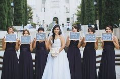 a bride and her bridal party holding up signs